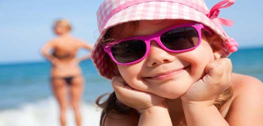 happy little girl on beach happy little girl at the seaside under an umbrella in the summer
