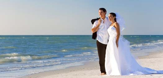 Bride & Groom Married Couple at Beach Wedding A married couple, bride and groom, together in sunshine on a beautiful tropical beach