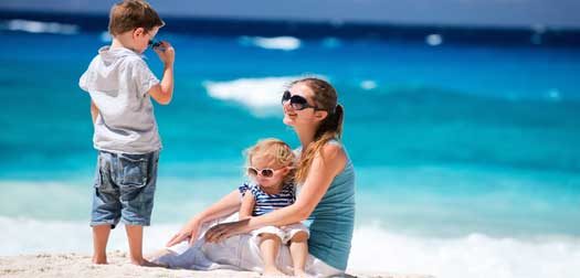 mother with her two kids Young mother with her two kids on beach vacation