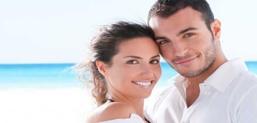 Smiling happy couple at summer beach