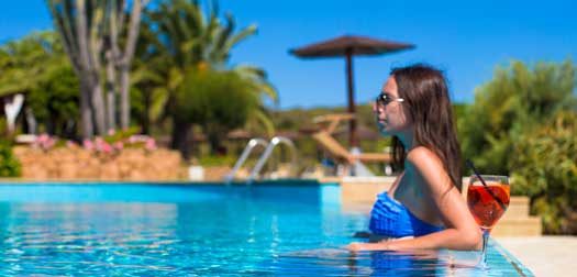 Beautiful young woman relaxing in swimming pool with cocktail Beautiful woman relaxing in swimming pool with tasty cocktail