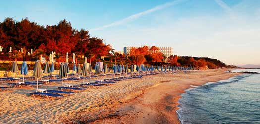 Sunbeds on a beach during sunrise, Halkidiki, Greece Sunbeds on a beach during sunrise, Halkidiki, Greece