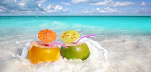 coconut cocktails juice in tropical beach water splash turquoise caribbean
