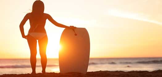 Water sport bodyboarding surfer woman beach travel Water sport bodyboarding surfer woman on summer beach vacation holidays travel. Surfing girl holding bodyboard looking at ocean sea and sunshine. Beach bikini babe. Kaanapali beach, Maui, Hawaii.
