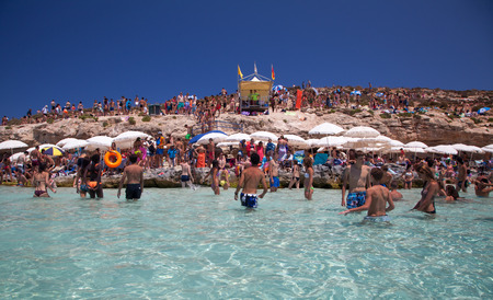 sunbathing at blue lagoon at comino
