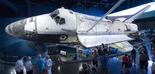 kennedy-space-centre 56983501 - kennedy space center, florida, usa - april 27, 2016: visitors looking at space shuttle atlantis which is exhibited at the visitor complex of kennedy space center