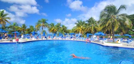pool saint lucia, caribbean - tourists relax by the pool in exotic resort in saint lucia, caribbean