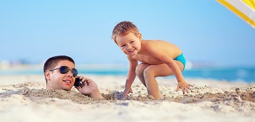kid playing around in sand.
