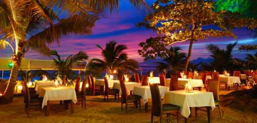 Outdoor restaurant at the beach during sunset